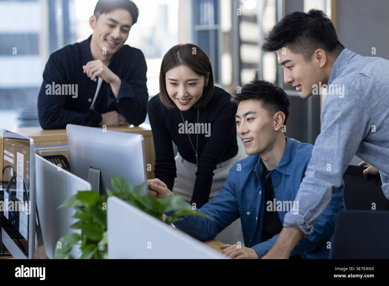 Chinese IT experts working together on computer in office Stock Photo