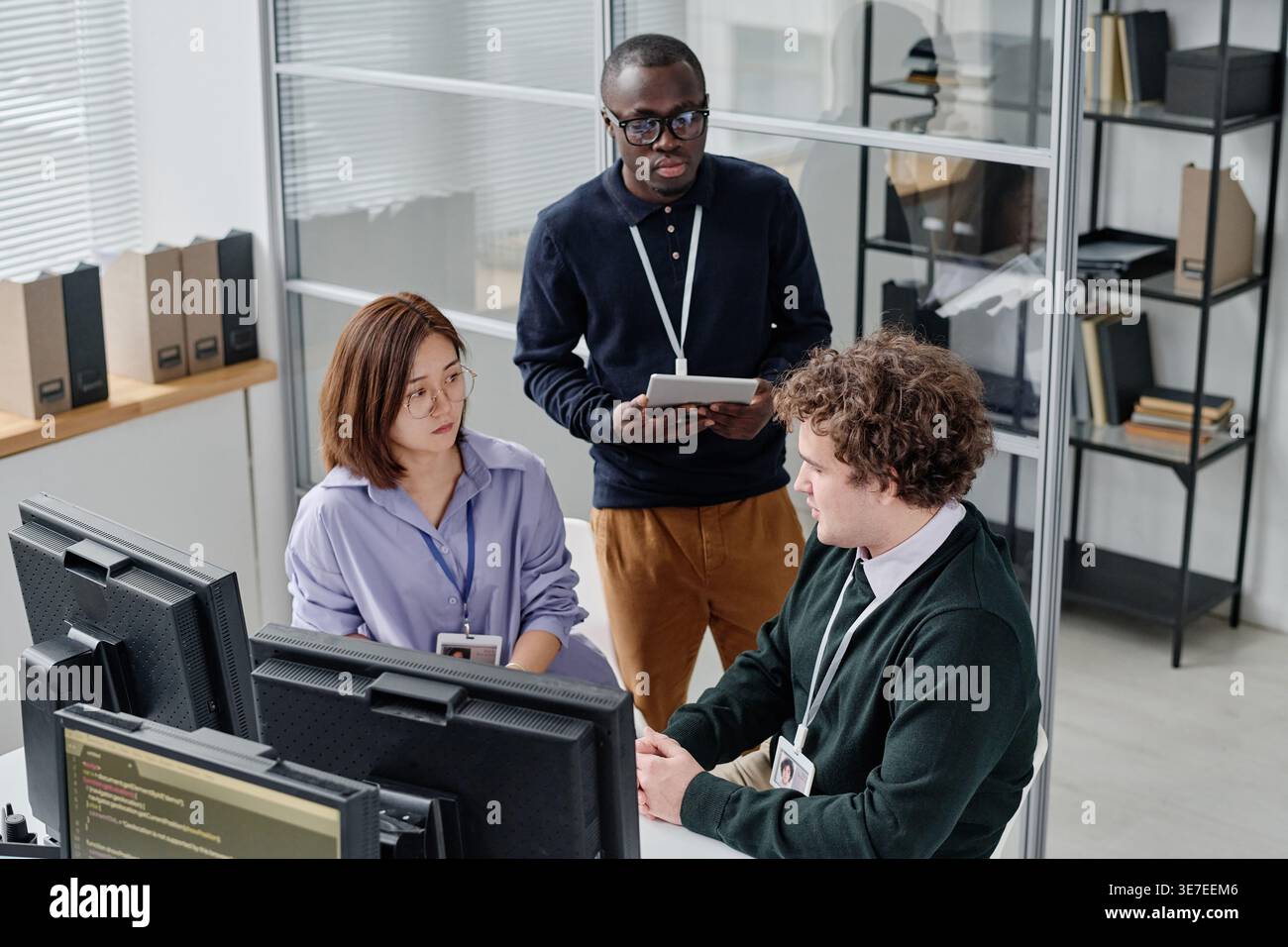 Diverse group of developers discussing new program working together in office Stock Photo