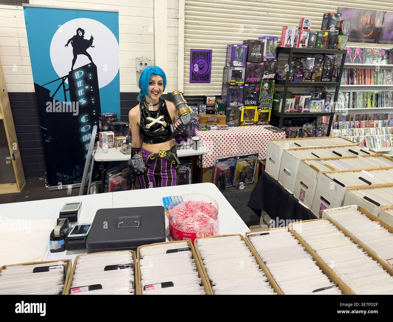 A woman with blue hair, selling Anime, Cosplay items. At Comic Con theme sale at EPIC market in Canberra, Australia. Stock Photo