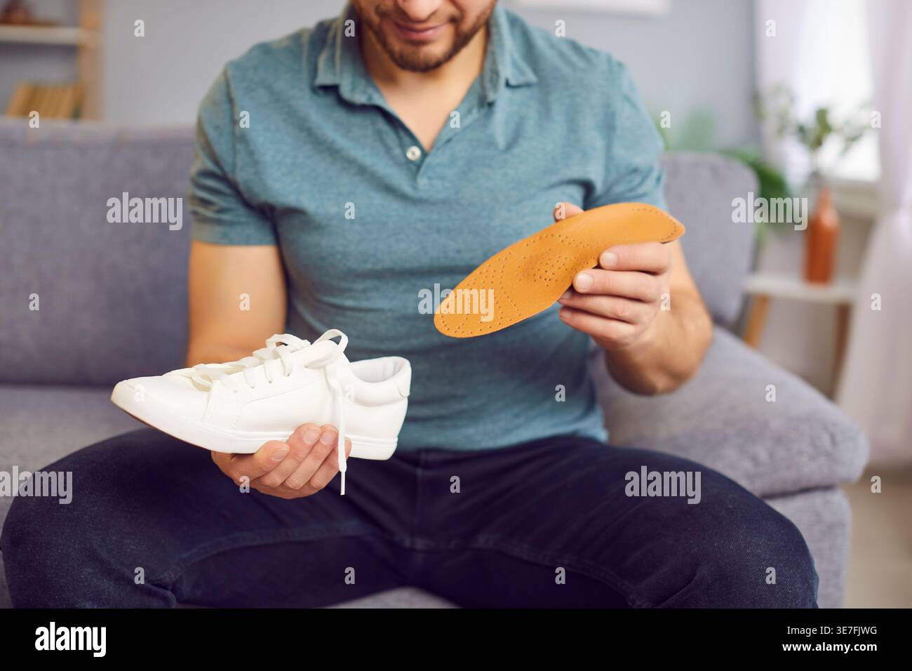 Orthopedist Inserts Insole Into Shoe For Foot Health Stock Photo