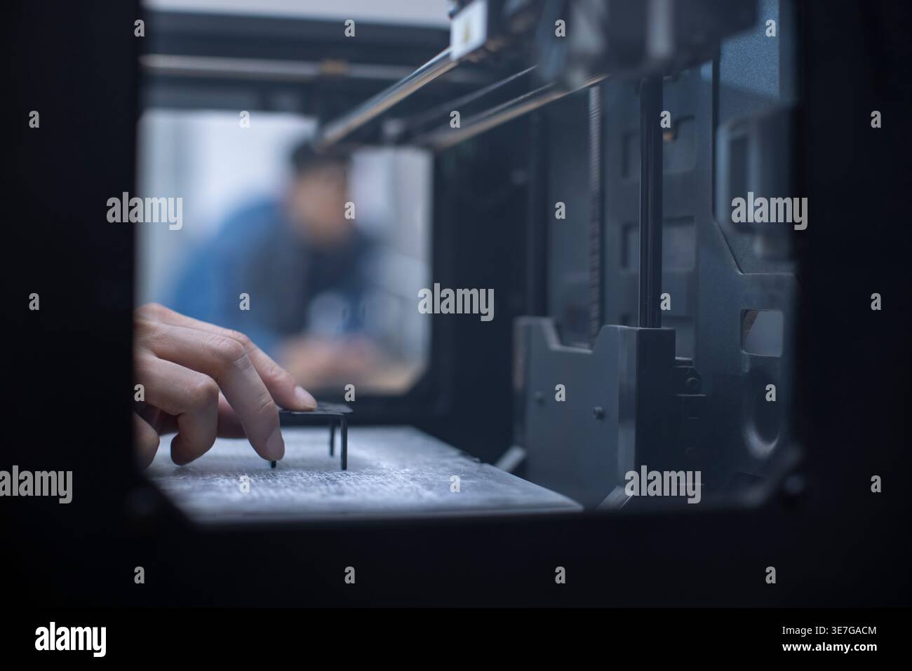 Chinese IT experts using 3D printer in office Stock Photo