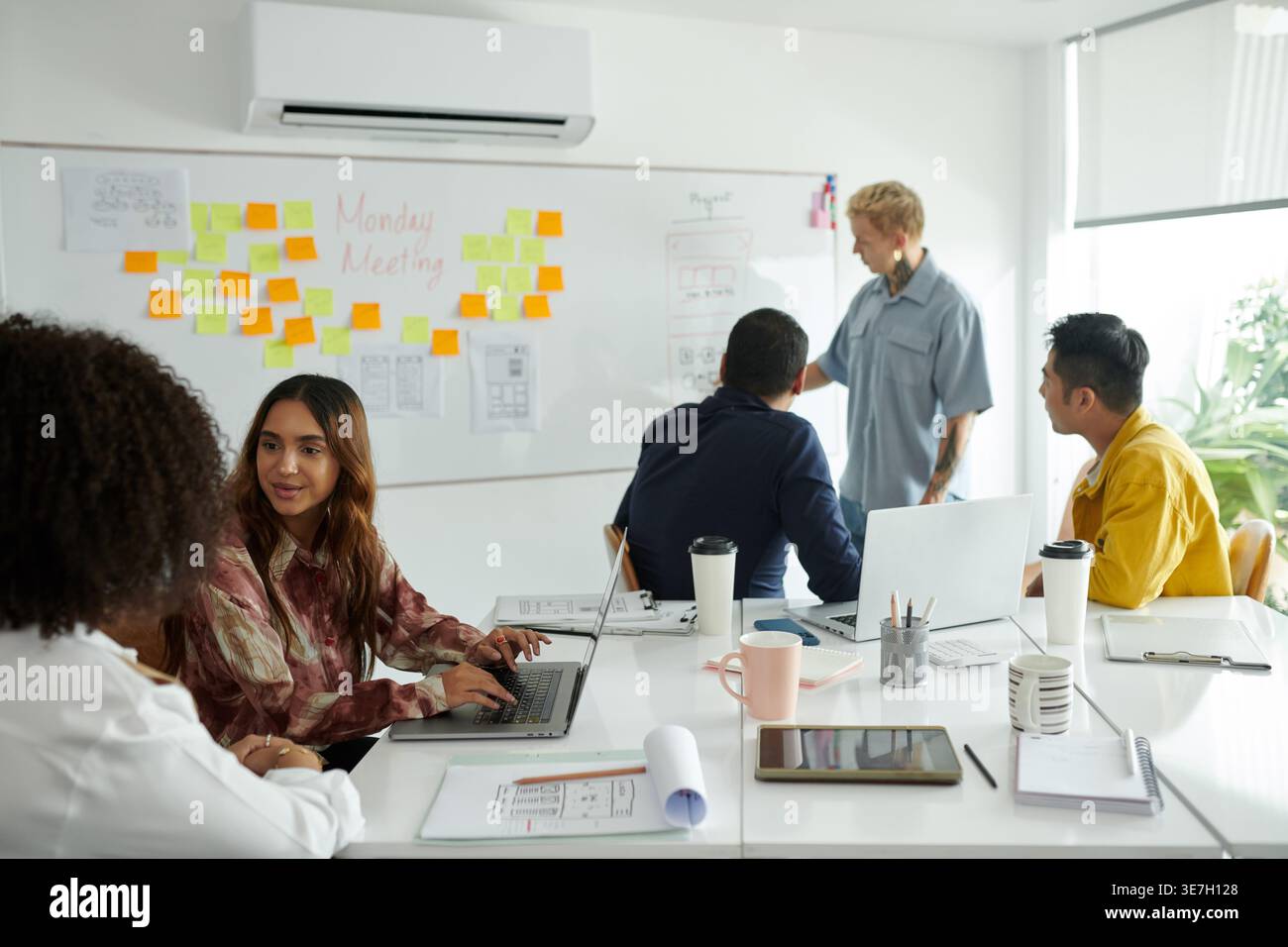 Group of developers working as team on new big project discussing programming code in office Stock Photo
