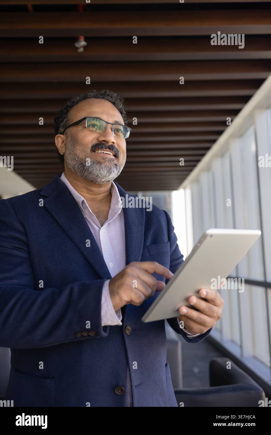 Confident businessman using tablet for business decisions Stock Photo