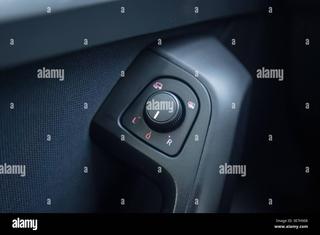Car interior side mirror control knob in close up Stock Photo