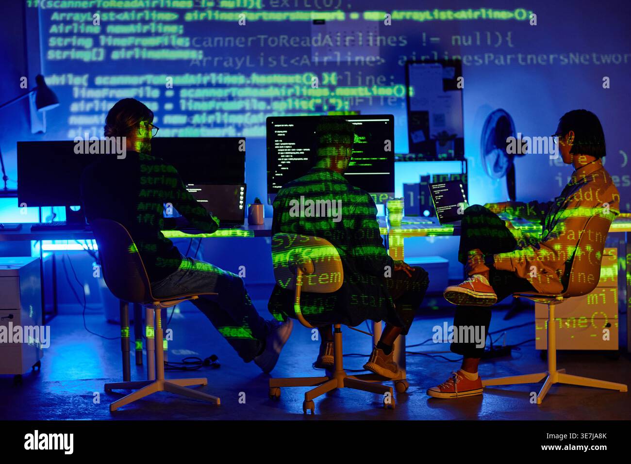 Diverse group of programmers using computers working together sitting at table in offce Stock Photo