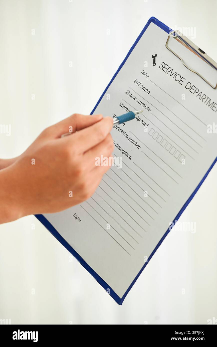 Cropped image of Asian repairman hands pointing on document information Stock Photo