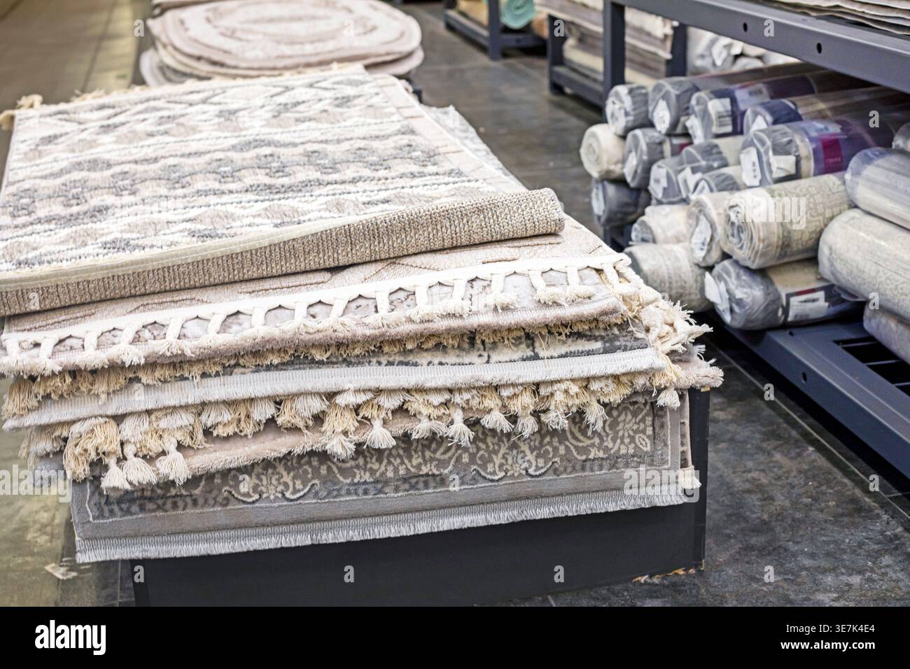 Various carpet samples with textures and patterns on the table and shelves Stock Photo