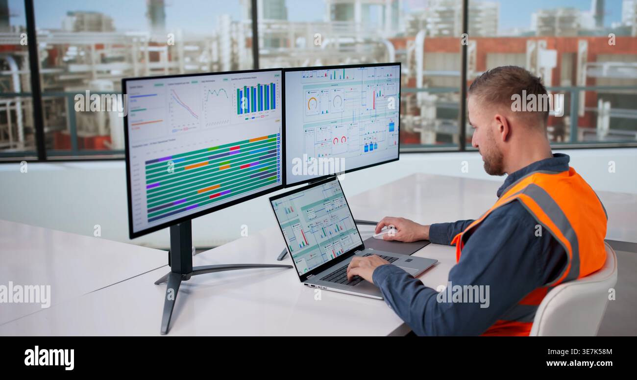 Engineer Oversees Automated Computer Systems Managing Gas And Oil Production Processes Stock Photo