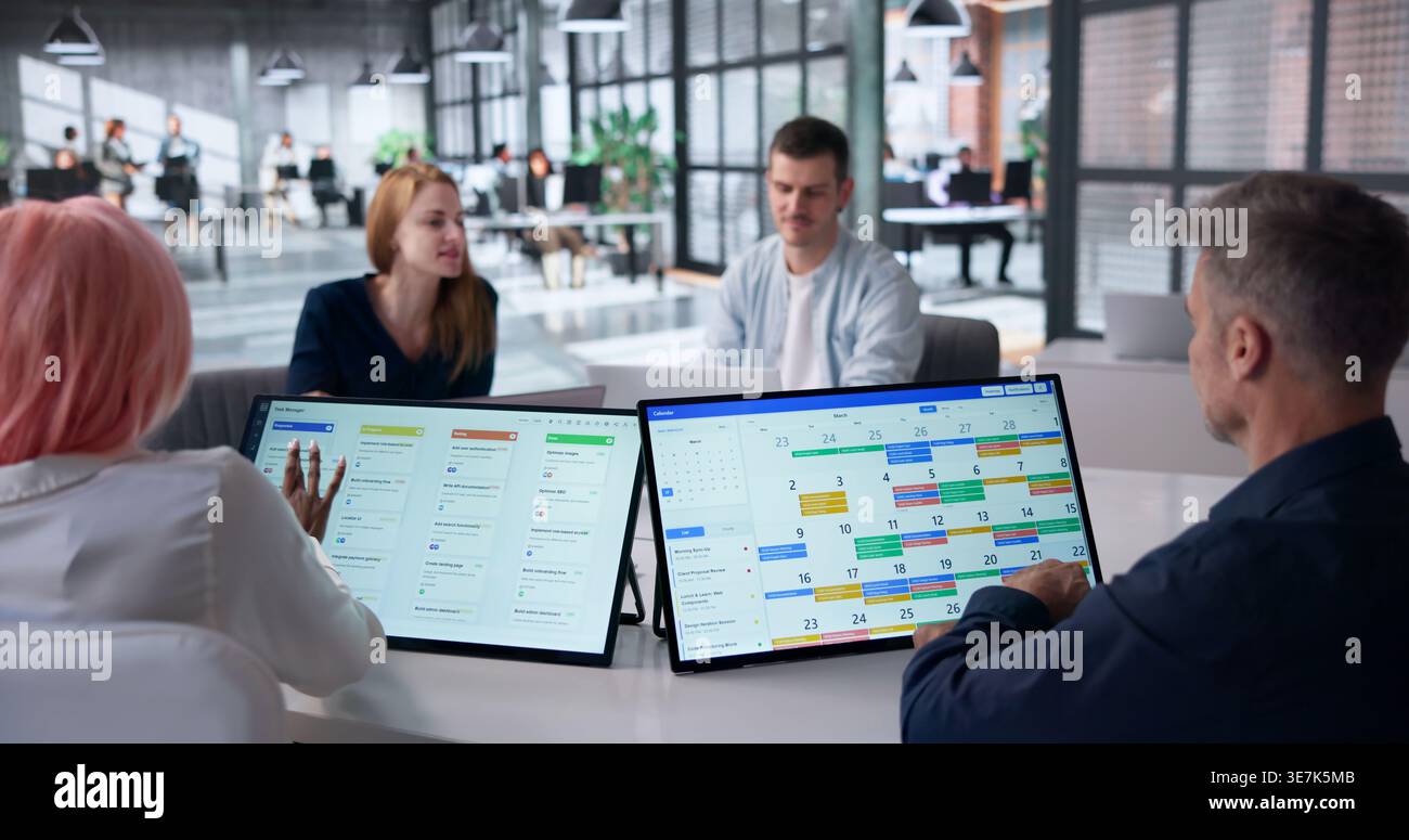 Project Manager Leading Diverse Team Discussion Using Kanban And Calendar Tools. Stock Photo
