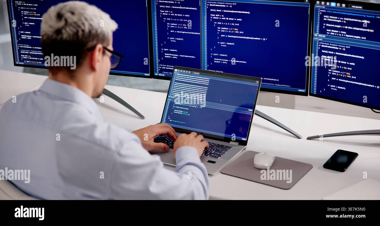 Hispanic Software Developer Working On Coding And Cybersecurity Solutions In Office Environment Stock Photo