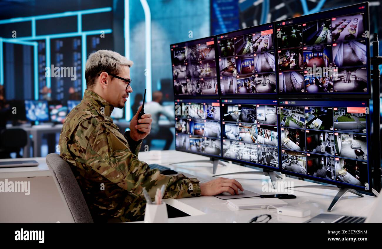 Military Analyst Overseeing Satellite Intelligence Systems In Secure Operations Center Stock Photo