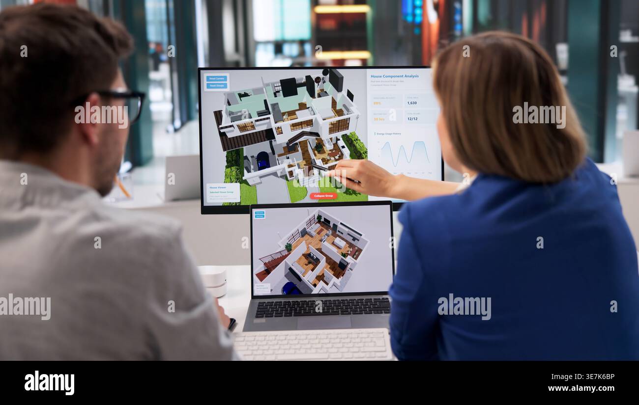 Architect Examines 3D Home Model On Computer For Renovation Plan Stock Photo