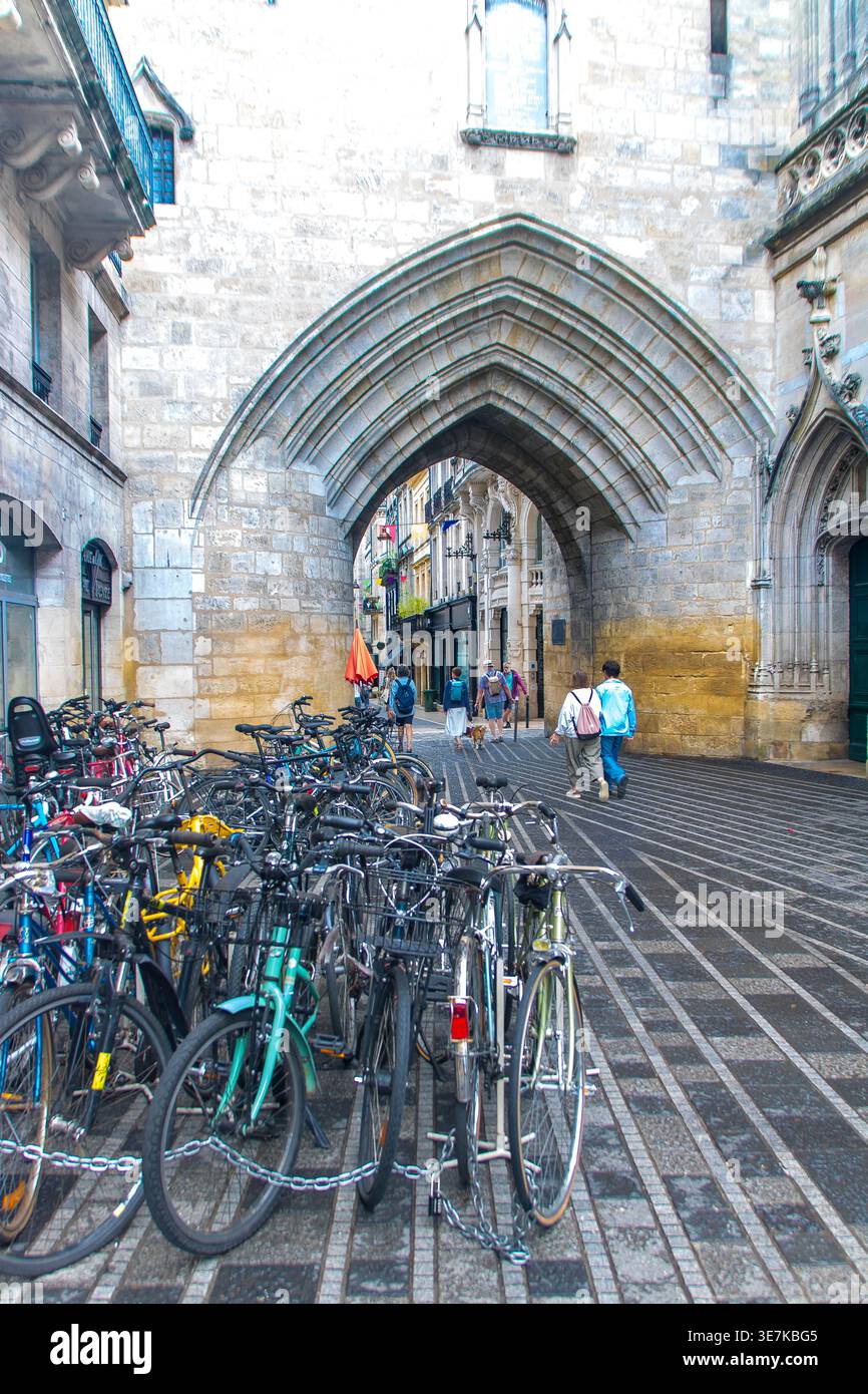 At Bordeaux , France, On 08,30,25, Bicycles parked in front of the Grosse Cloche medieval gate,  urban lifestyle. Stock Photo