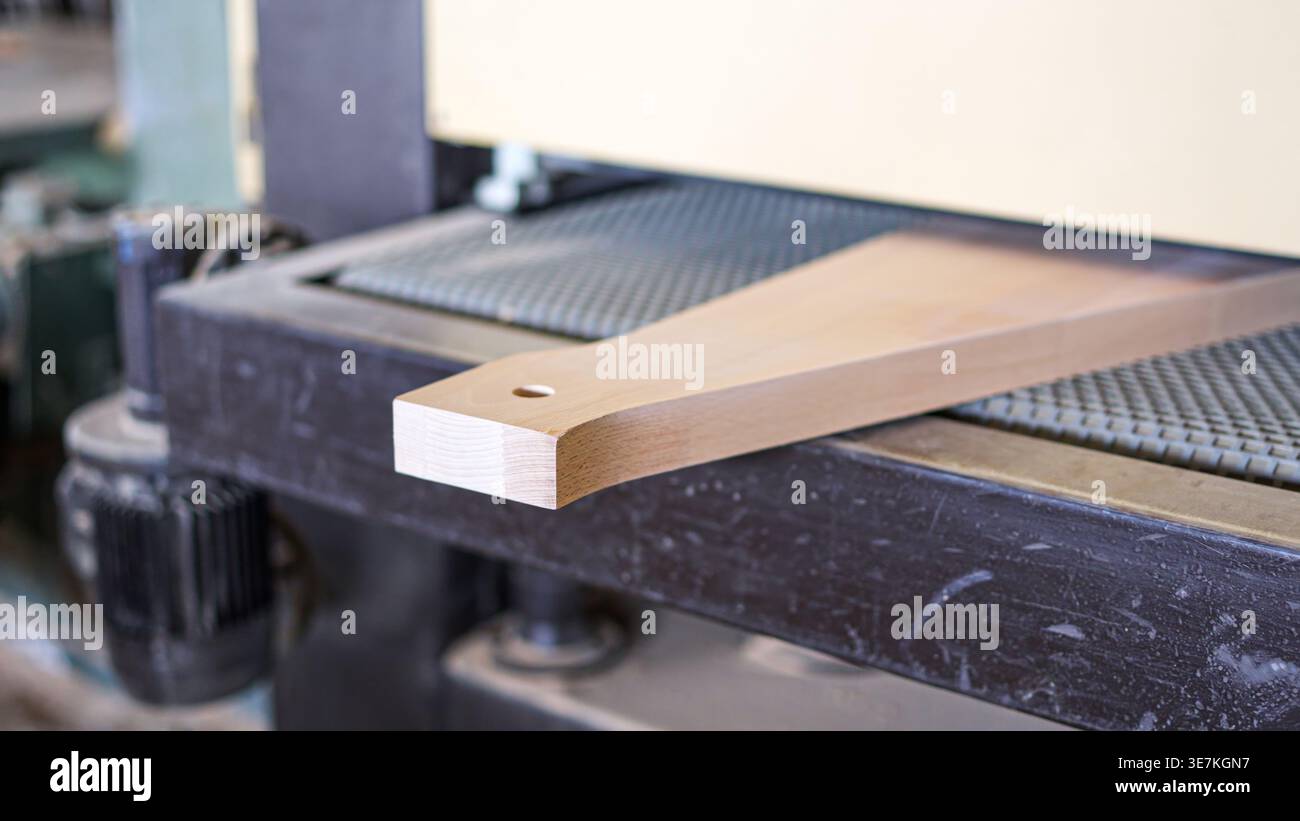 Precision woodworking machinery sanding timber component in workshop Stock Photo
