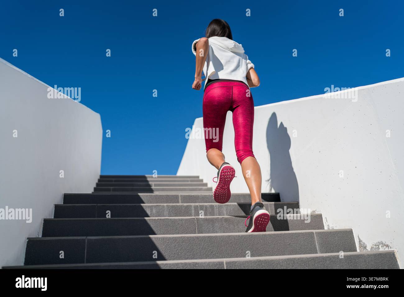 Woman doing run up on staircase Stock Photo