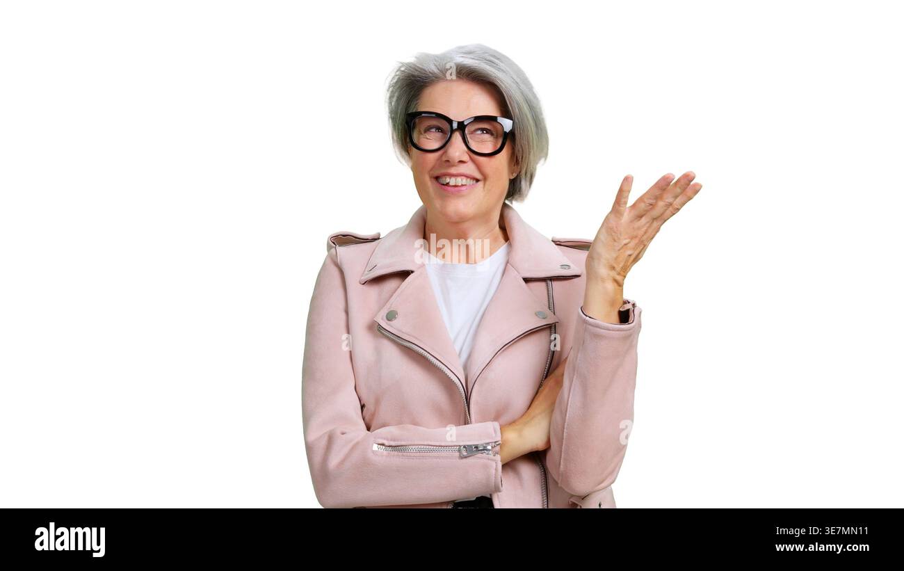 Senior woman smiling gesturing presenting isolated white background Stock Photo