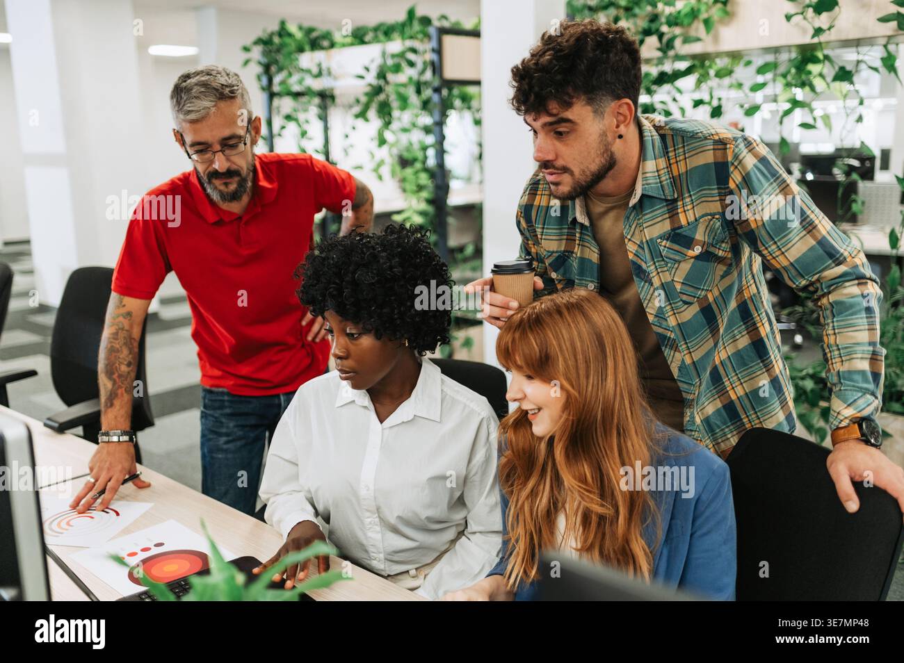Group of business people discussing project plan using computer and analyzing chLifestyle working together in office Stock Photo