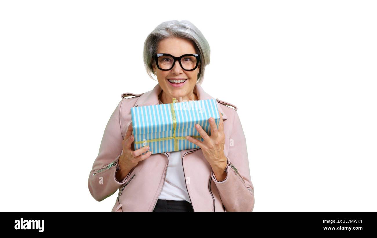Senior woman holding gift gift box celebrating Stock Photo