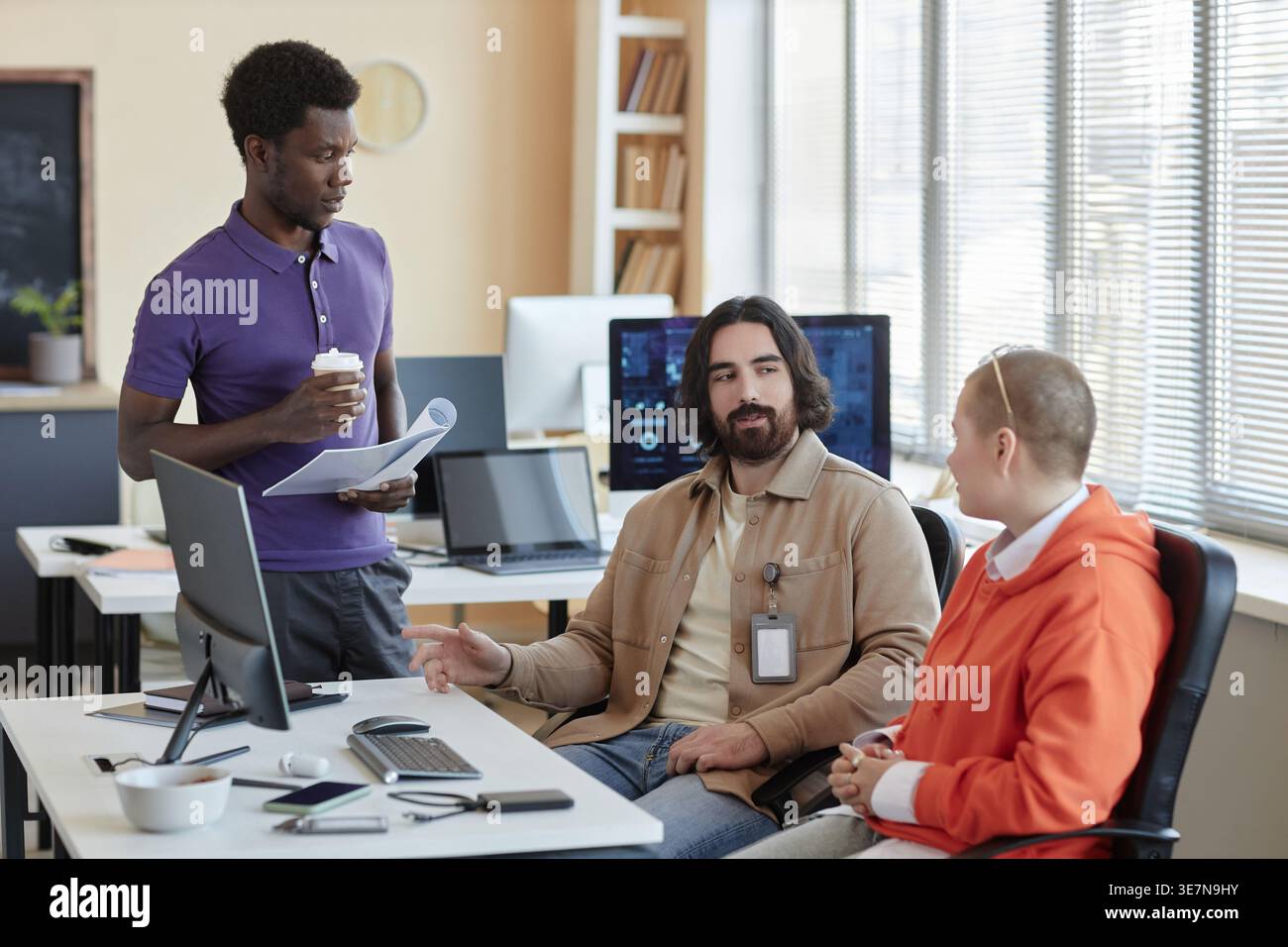 Group of programmers discussing working ideas while on meeting in office workplace Stock Photo