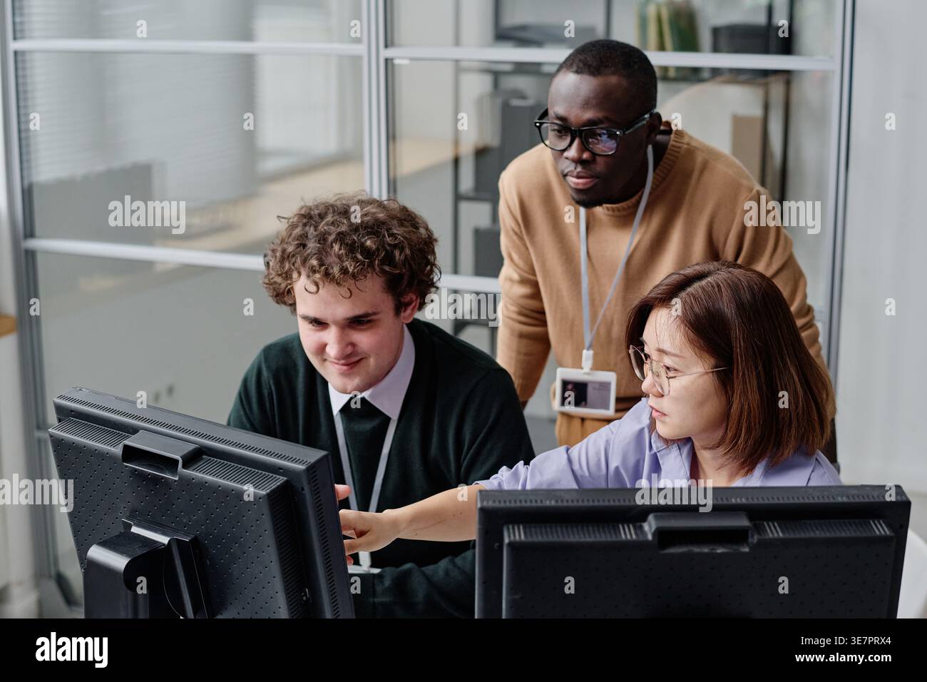 Diverse group of programmers developing security program on computers during their work in office Stock Photo