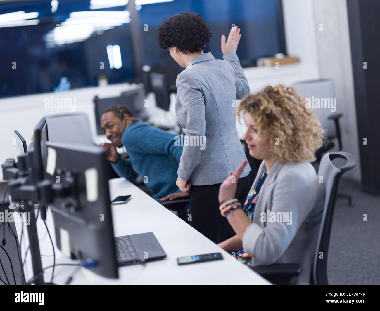 Diverse workmates having fun while working together in office Stock Photo