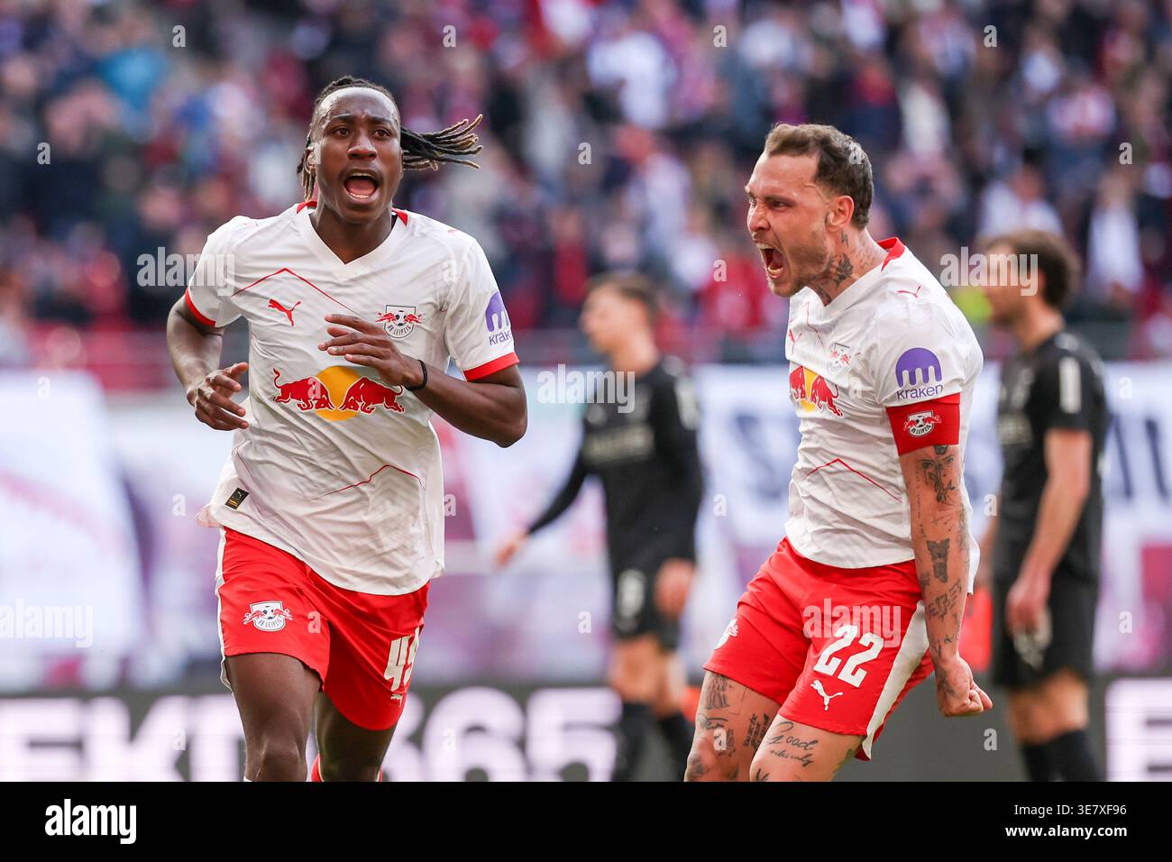 Leipzig's Yan Diomandé, left, celebrates next to David Raum after ...