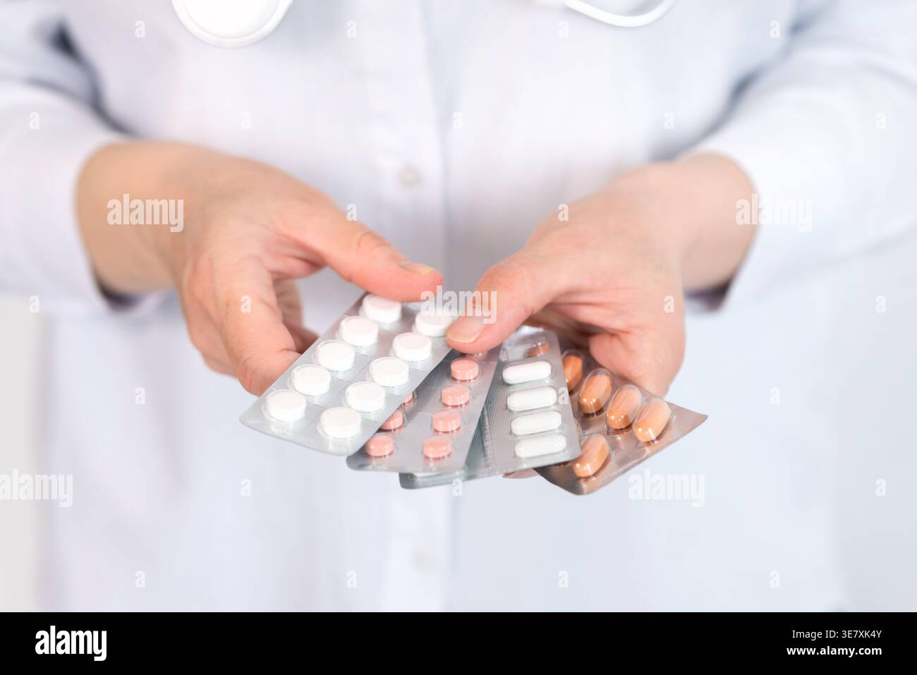 Close up of hands holding various blister packs with pills, pharmaceutical and healthcare concept Stock Photo