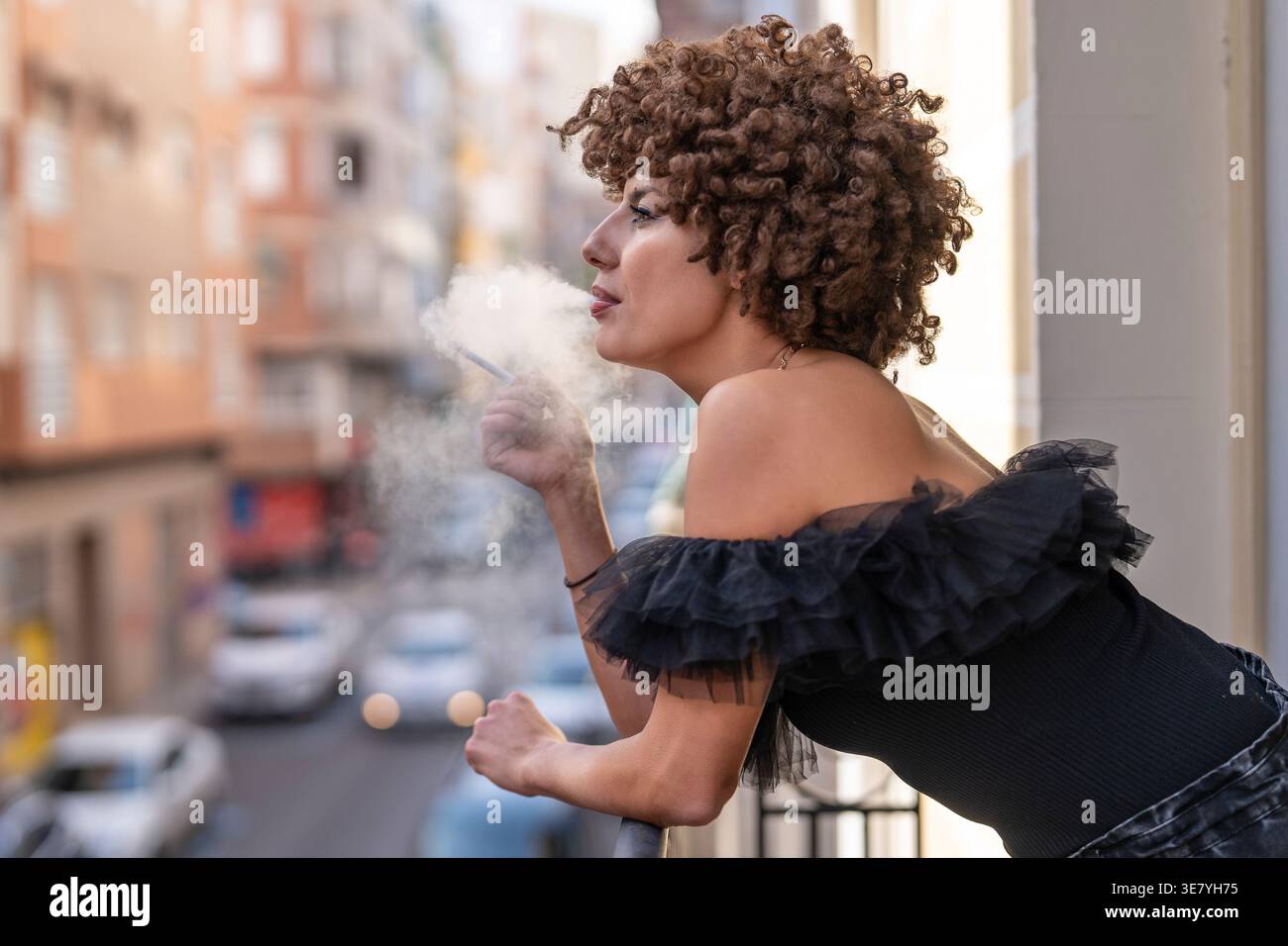 Smoking Railing Serious Middle Eastern woman smoking while leaning on a balcony railing ...