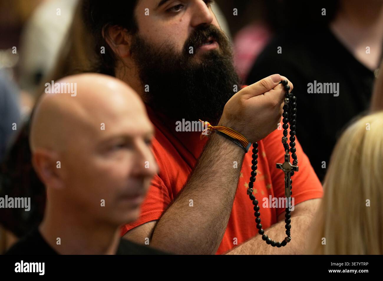 A man holds a rosary as he attends a vigil for peace lead by Pope Leo ...