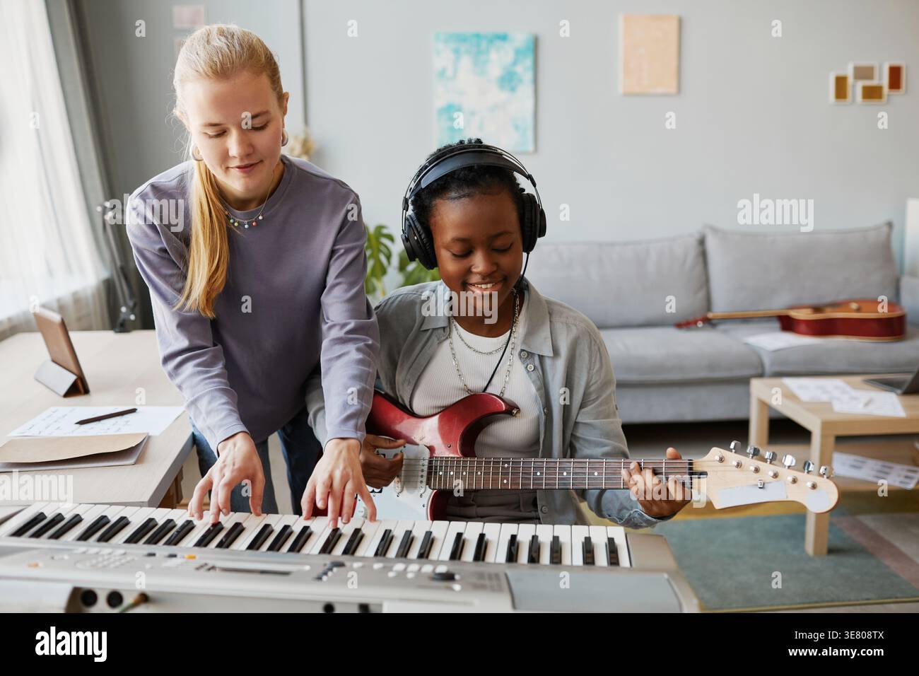 Diverse female musicians playing instruments in studio Stock Photo