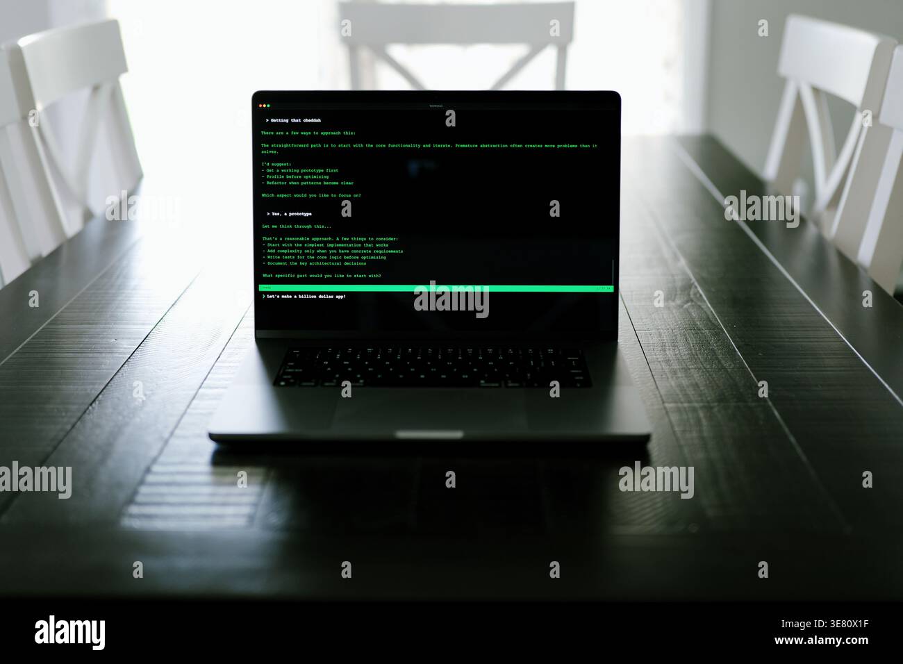 Vibe Coding Software Engineer Developing Billion Dollar Applications at Kitchen Table on Saturday Morning - AI Vibe Coder Concept Stock Photo