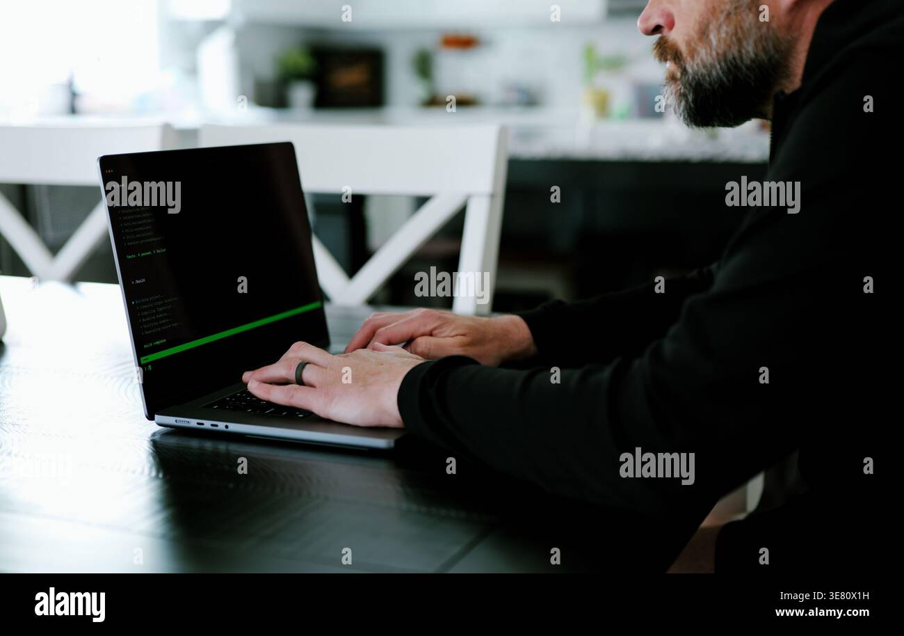 Vibe Coding Software Engineer Developing Billion Dollar Applications at Kitchen Table on Saturday Morning - AI Vibe Coder Concept Stock Photo