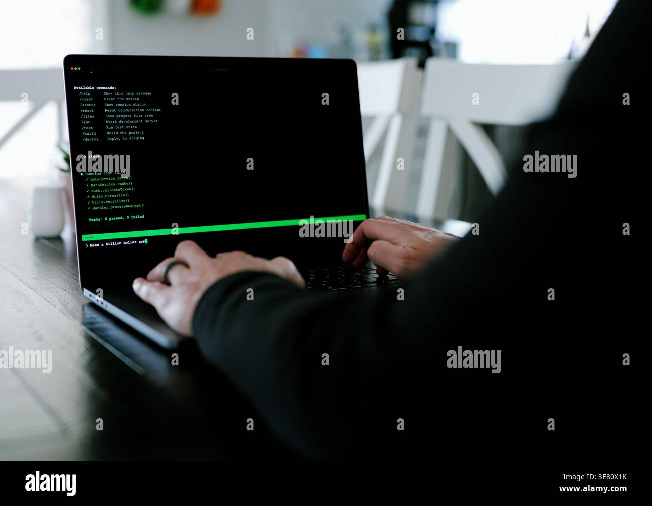 Vibe Coding Software Engineer Developing Billion Dollar Applications at Kitchen Table on Saturday Morning - AI Vibe Coder Concept Stock Photo