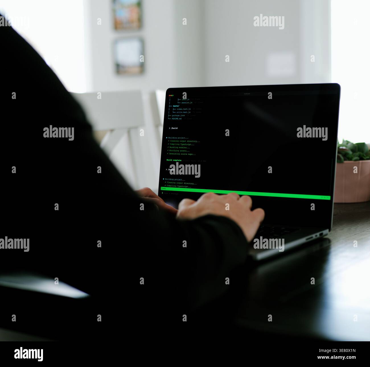 Vibe Coding Software Engineer Developing Billion Dollar Applications at Kitchen Table on Saturday Morning - AI Vibe Coder Concept Stock Photo