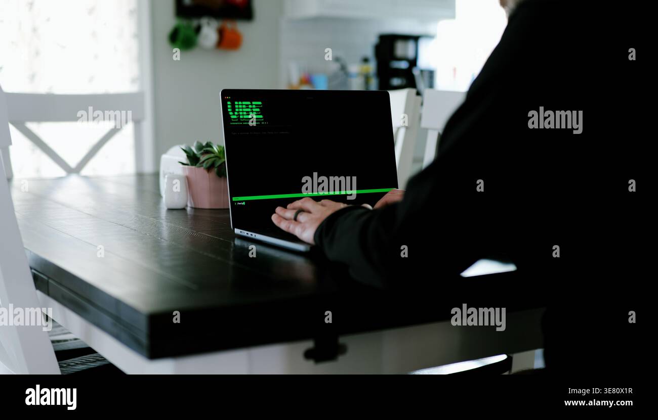 Vibe Coding Software Engineer Developing Billion Dollar Applications at Kitchen Table on Saturday Morning - AI Vibe Coder Concept Stock Photo