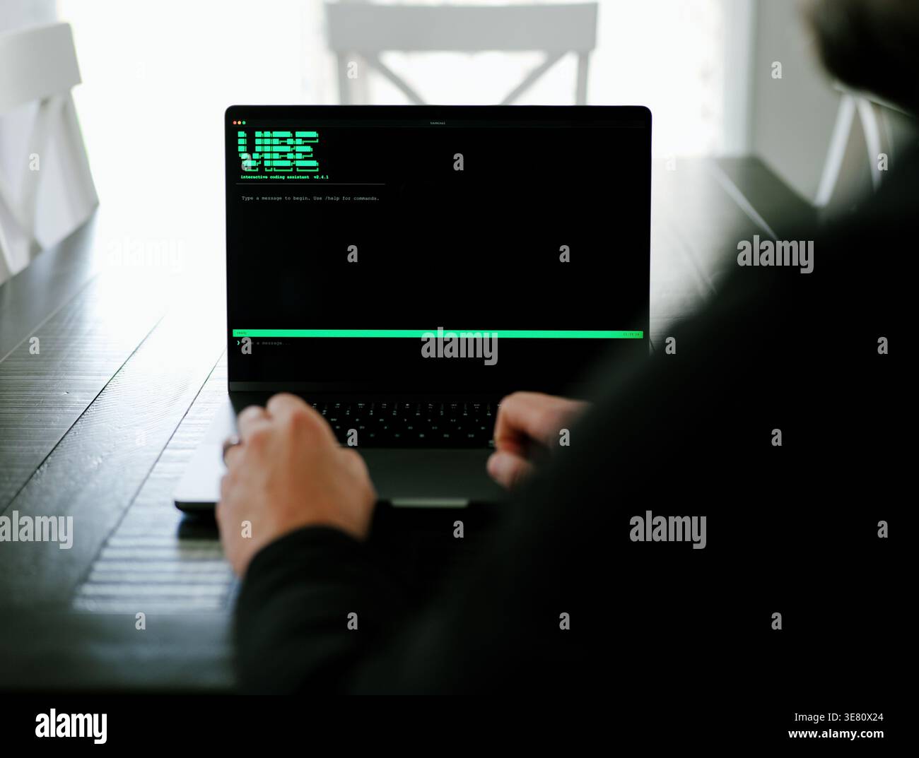 Vibe Coding Software Engineer Developing Billion Dollar Applications at Kitchen Table on Saturday Morning - AI Vibe Coder Concept Stock Photo