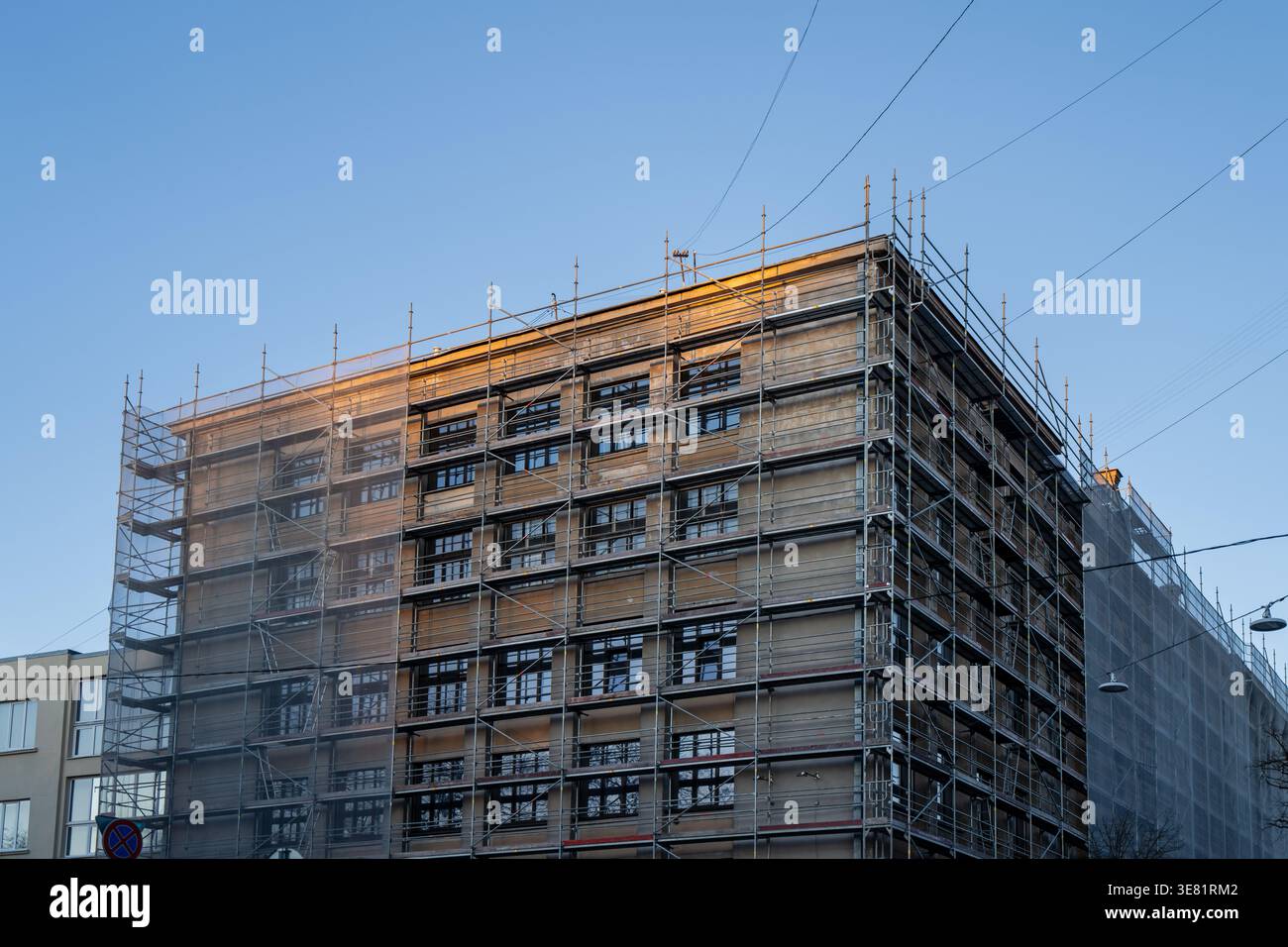 Street side building under facade reconstruction with full perimeter ...