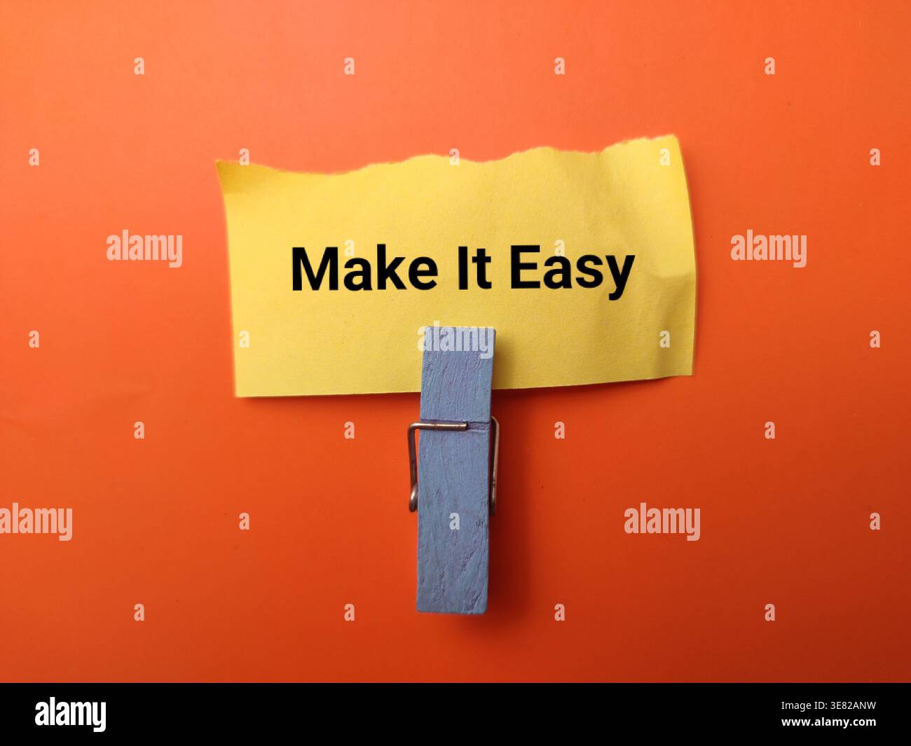 The text Make It Easy is written on a yellow sticky note. Stock Photo