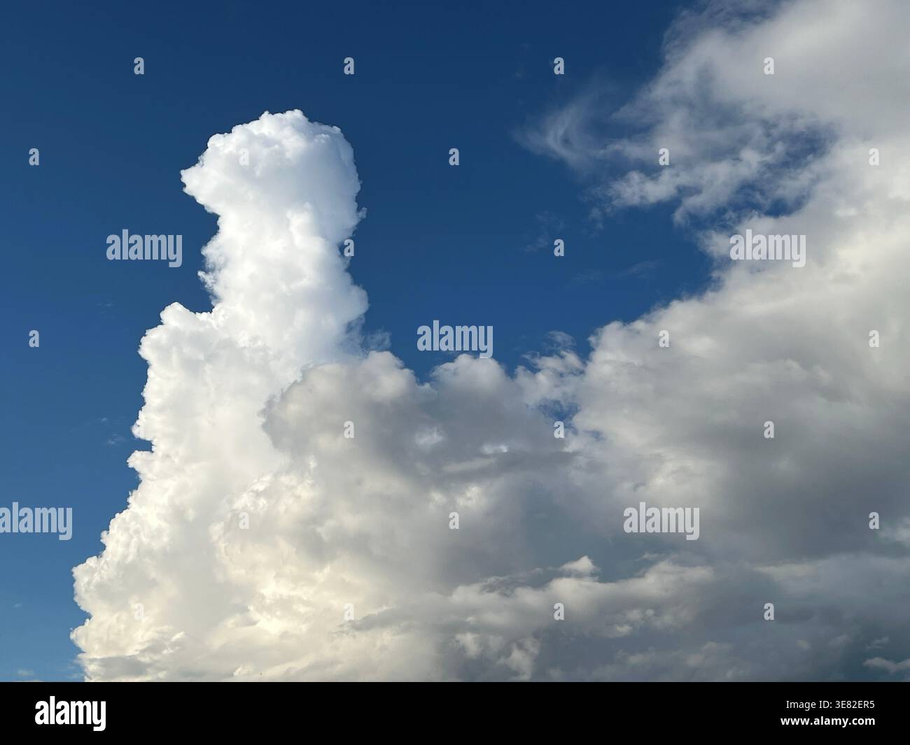 Cumulus cloud formation against a blue sky Stock Photo