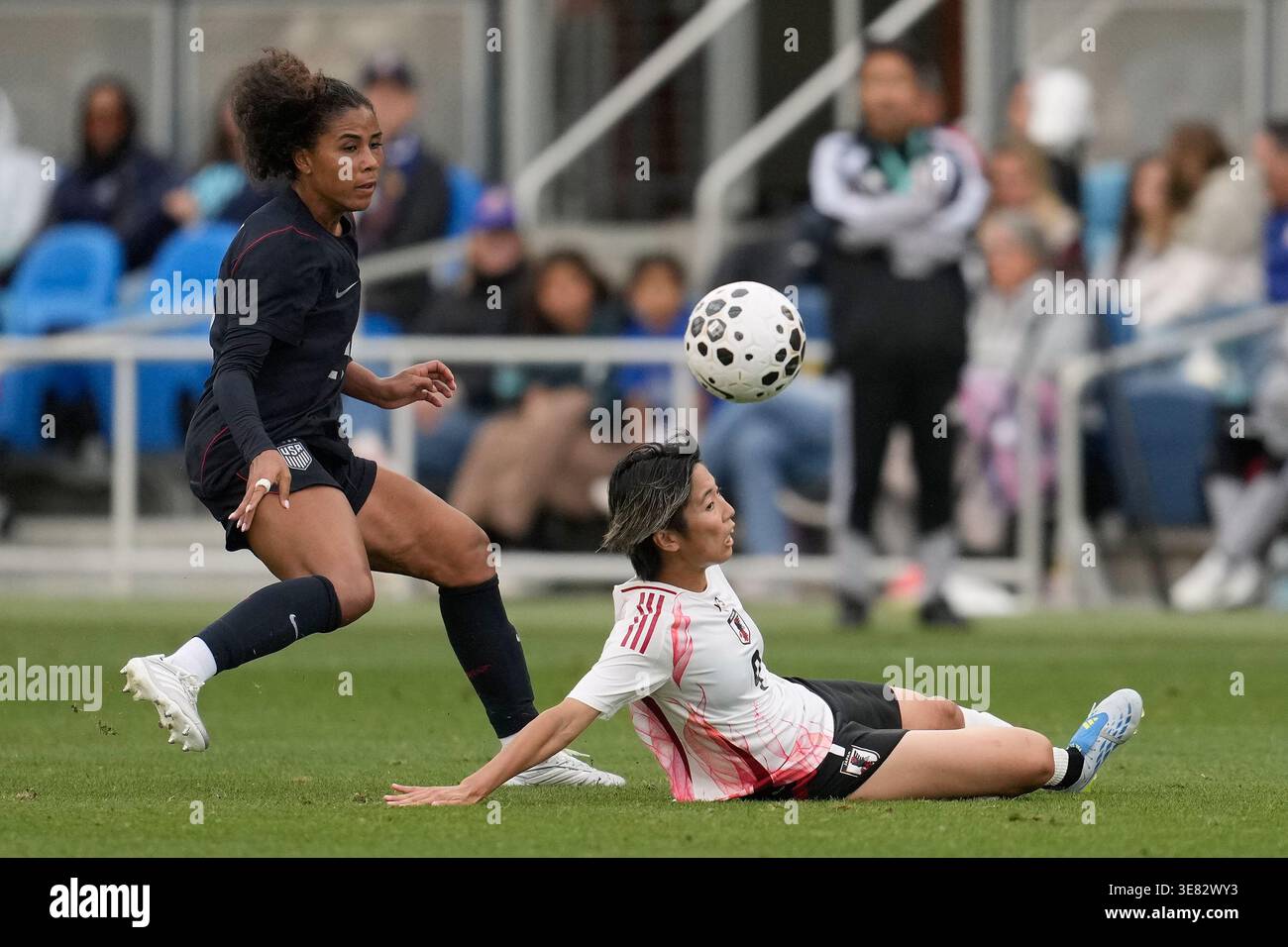 S Riko Japan's Riko Ueki, bottom, slides under the ball next to the United ...