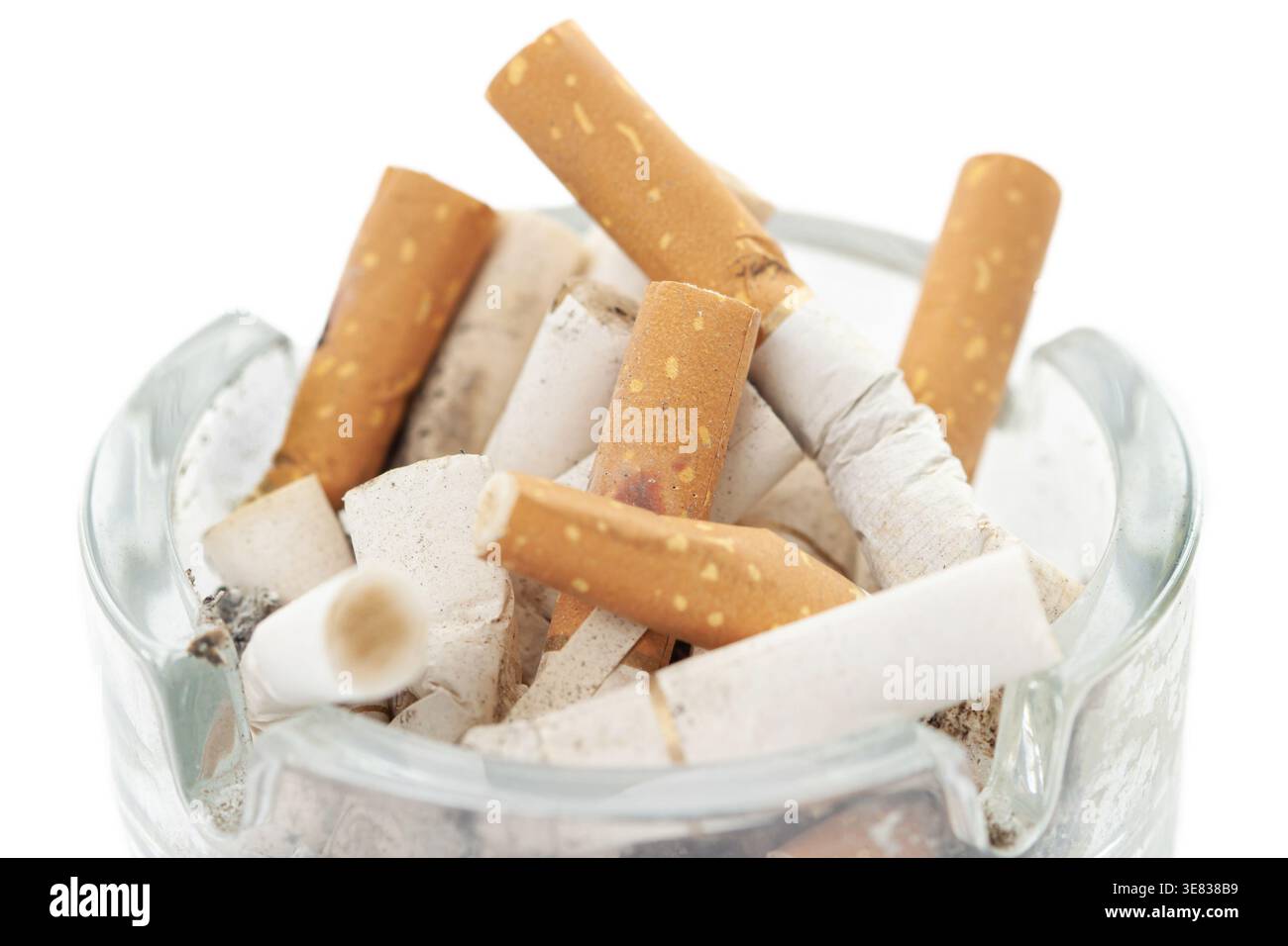 Bunch used cigarettes inside ashtray isolated white background macro Stock Photo