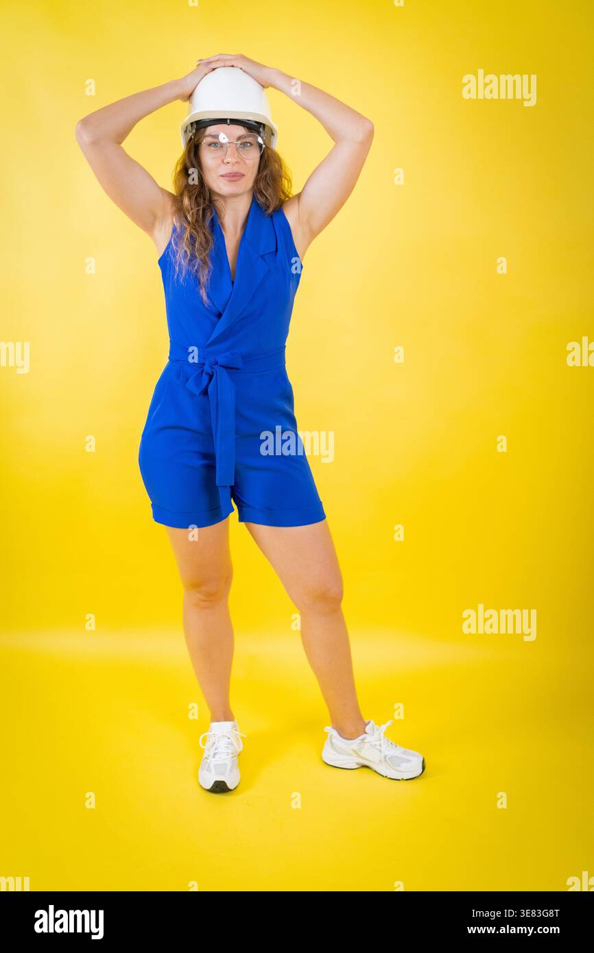 Woman wearing hard hat and safety glasses protection Stock Photo