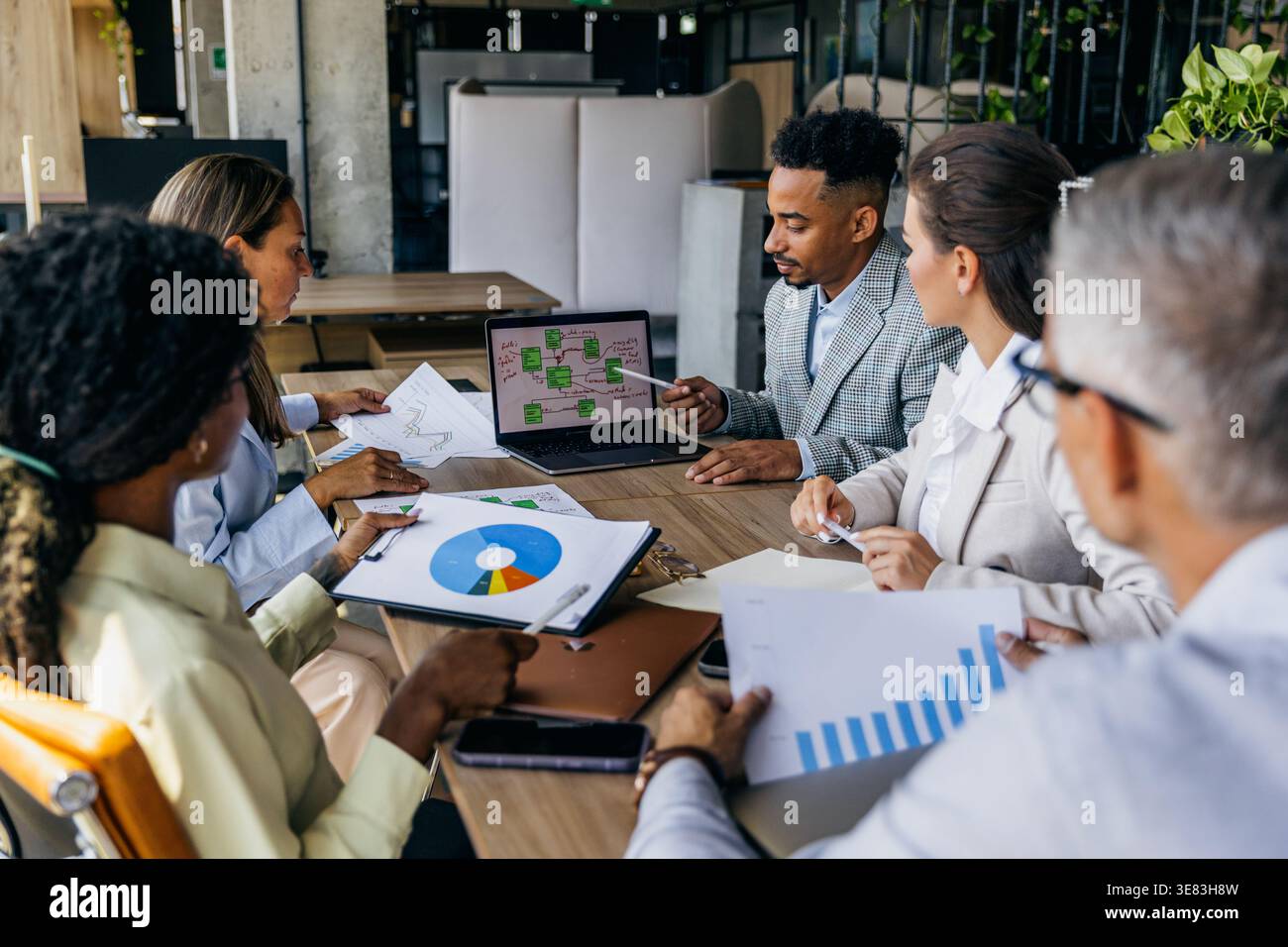 Modern Workspace Where Diverse Opinions Are Valued During Data Analysis And Decision Making Stock Photo