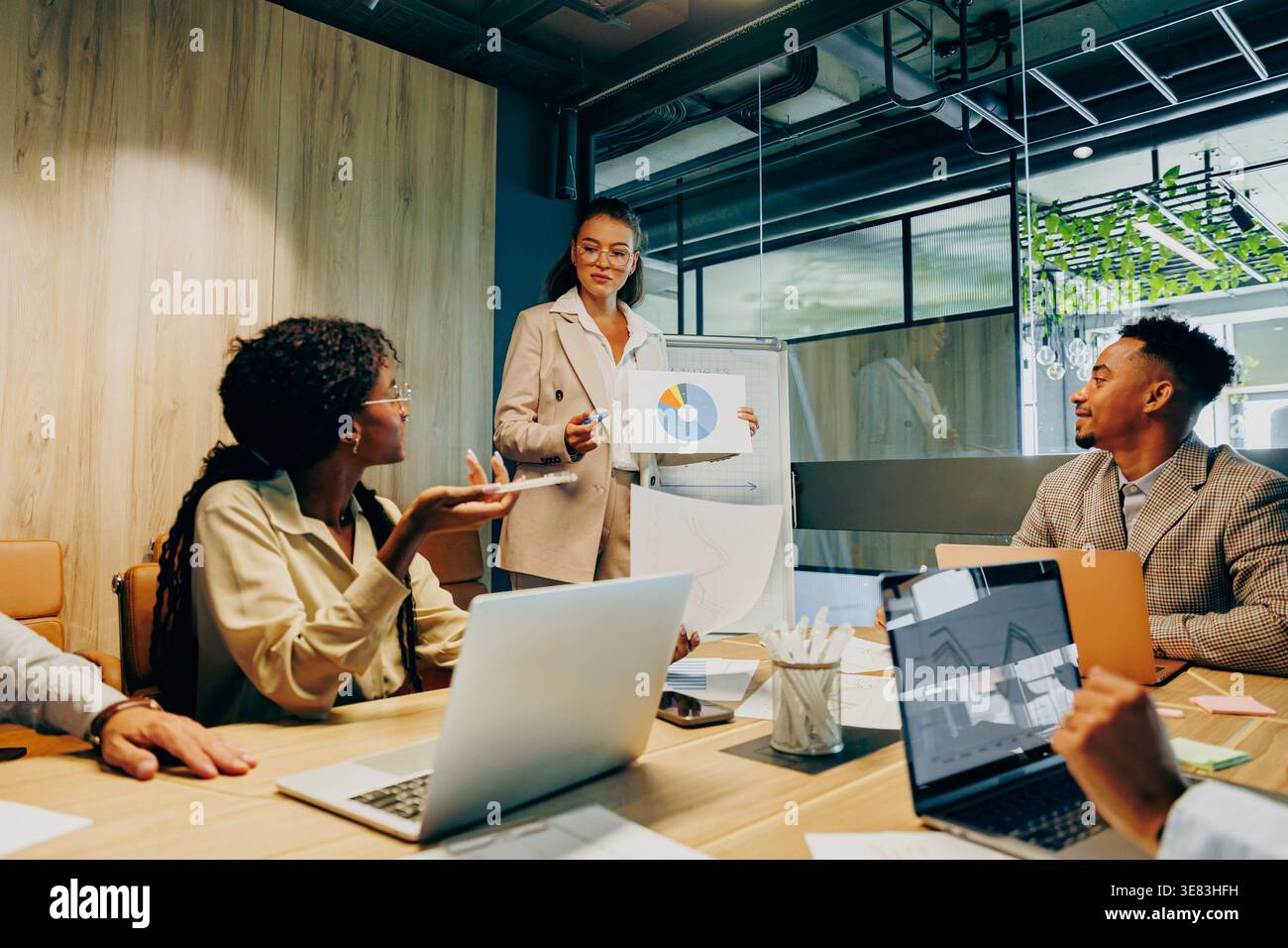 Asian project manager celebrating results with black colleagues Stock Photo