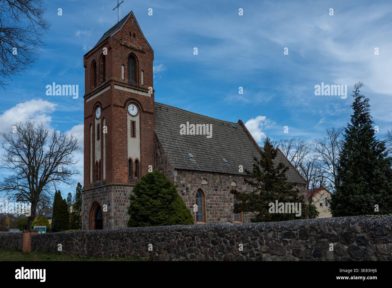 Fieldstone Clock Historic fieldstone church in Schwanebeck, Barnim, Germany, with a tall ...