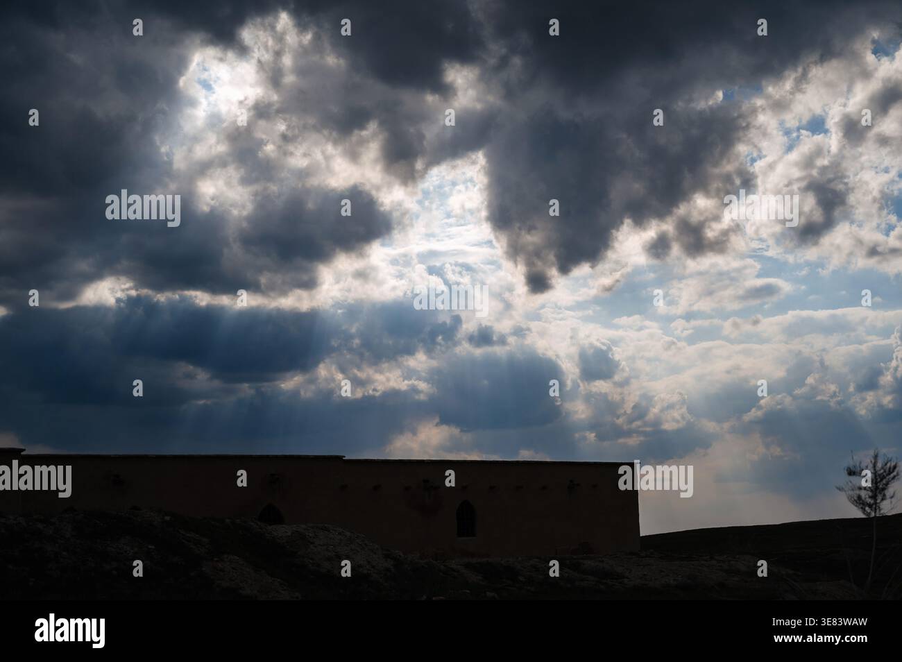 Dramatic dark clouds with penetrating rays of light. Stock Photo