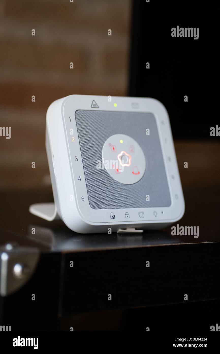 Smart security hub sitting on a wooden surface Stock Photo