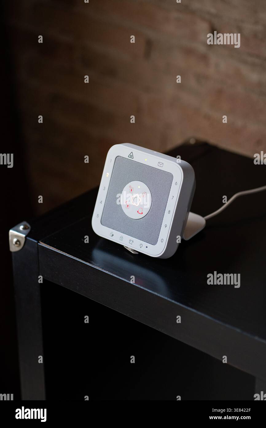 Modern smart home security keypad on a dark table with touchscreen interface Stock Photo