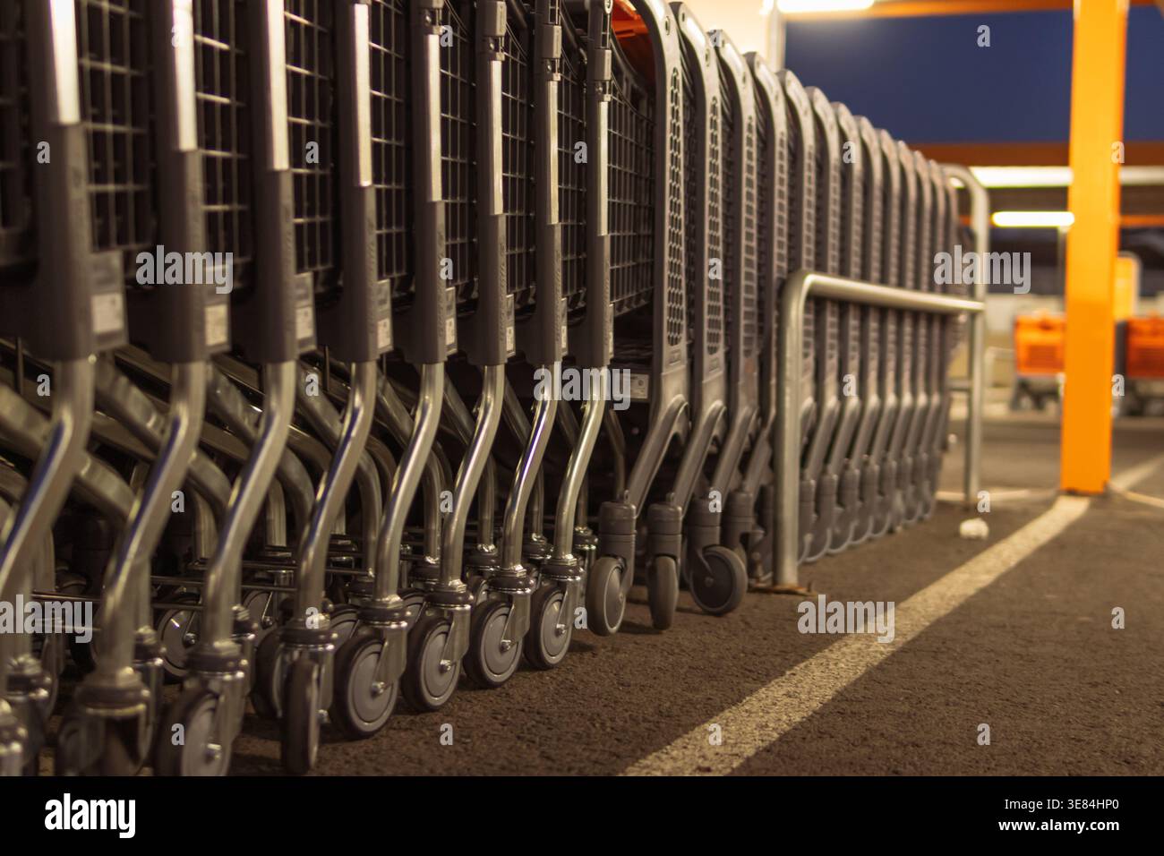 Shopping carts lined up in a row at a grocery store parking lot at ...