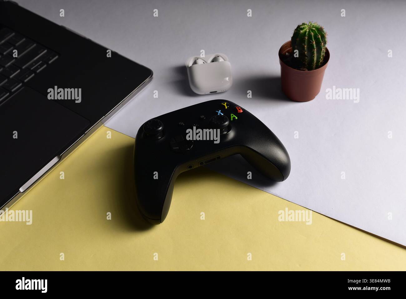 Black videogame controller on desk surface Stock Photo